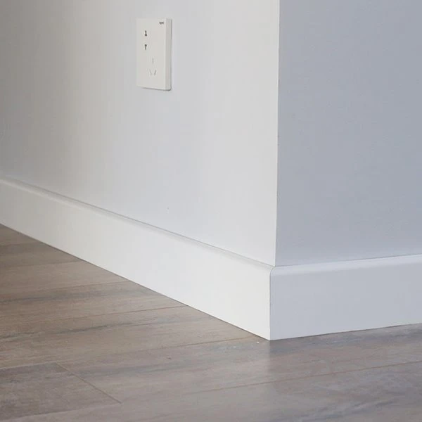 Close-up profile view of white PVC crown moulding showing smooth extruded surface finish and detailed classical profile geometry with cove and bead details