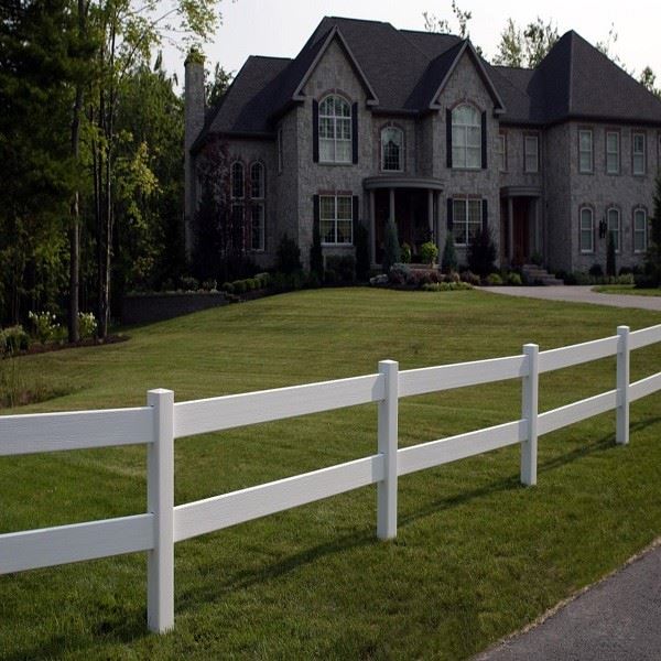 White 2-rail vinyl ranch rail fence installed across green pasture with evenly spaced vertical posts and two horizontal rails creating open sightlines through the fence for livestock visibility and landscape views White 2-rail vinyl ranch rail fence installed across green pasture with evenly spaced vertical posts and two horizontal rails creating open sightlines through the fence for livestock visibility and landscape views
