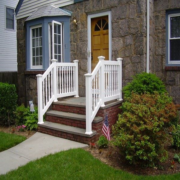 White vinyl step railing installed on a residential front staircase with five steps, continuous top handrail, square-profile balusters, and base rail mounted to concrete tread surface White vinyl step railing installed on a residential front staircase with five steps, continuous top handrail, square-profile balusters, and base rail mounted to concrete tread surface